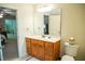 Bright bathroom with oak vanity, large mirror, and an open doorway to the main bedroom at 7371 Leasburg Rd, Roxboro, NC 27574
