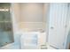 Bathroom with a shower, soaking tub with tile surround, and white tile flooring at 7371 Leasburg Rd, Roxboro, NC 27574