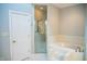 Bathroom with a glass shower, soaking tub with tile surround, and white tile flooring at 7371 Leasburg Rd, Roxboro, NC 27574
