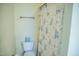 Bathroom with floral shower curtain and toilet at 7371 Leasburg Rd, Roxboro, NC 27574