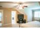 Comfortable bedroom with TV, ceiling fan, and open door leading to another room at 7371 Leasburg Rd, Roxboro, NC 27574