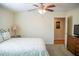 This bedroom has a ceiling fan and a dresser, along with a comfortable bed at 7371 Leasburg Rd, Roxboro, NC 27574