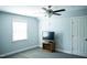 Bedroom featuring a ceiling fan, a window and a television on a TV stand at 7371 Leasburg Rd, Roxboro, NC 27574