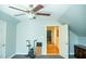 Upstairs bedroom features gray walls, ceiling fan and door to hallway with hardwood floors at 7371 Leasburg Rd, Roxboro, NC 27574