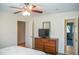 Bedroom featuring a ceiling fan, dresser with TV, and a view into another room at 7371 Leasburg Rd, Roxboro, NC 27574