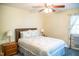 Bedroom with ceiling fan, side tables and blue patterned bedding at 7371 Leasburg Rd, Roxboro, NC 27574