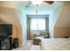 Bedroom features a chaise lounge, window, and ceiling fan at 7371 Leasburg Rd, Roxboro, NC 27574