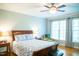 A sunny bedroom with a large bed, a comfortable armchair, and large windows at 7371 Leasburg Rd, Roxboro, NC 27574