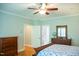 Bright bedroom with a dresser, hardwood floors, and open doors at 7371 Leasburg Rd, Roxboro, NC 27574