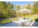 Inviting deck with outdoor seating and a grill, surrounded by a lush, green landscape at 7371 Leasburg Rd, Roxboro, NC 27574