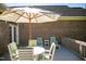 Outdoor deck featuring a table, chairs, and a striped umbrella, perfect for relaxing at 7371 Leasburg Rd, Roxboro, NC 27574