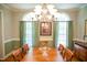 Charming dining room with hardwood floors, large windows, and a classic chandelier above the table at 7371 Leasburg Rd, Roxboro, NC 27574
