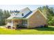 Charming brick home with a welcoming front porch and lush green lawn at 7371 Leasburg Rd, Roxboro, NC 27574