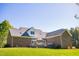 Rear view of a brick home, featuring a large deck for outdoor relaxation and entertaining at 7371 Leasburg Rd, Roxboro, NC 27574