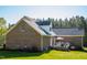 Brick home exterior with a large deck and outdoor seating area for entertaining at 7371 Leasburg Rd, Roxboro, NC 27574