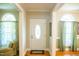 Inviting foyer with hardwood floors, decorative front door, and arched windows providing natural light at 7371 Leasburg Rd, Roxboro, NC 27574