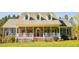 Charming brick home featuring a welcoming front porch and lush green lawn at 7371 Leasburg Rd, Roxboro, NC 27574