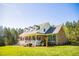 Beautiful brick home with a welcoming front porch, surrounded by trees at 7371 Leasburg Rd, Roxboro, NC 27574