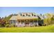 Inviting two-story brick home with a covered front porch and manicured lawn at 7371 Leasburg Rd, Roxboro, NC 27574