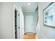 Hallway with hardwood floors leading to the staircase at 7371 Leasburg Rd, Roxboro, NC 27574