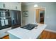 Bright kitchen with white cabinets, stainless steel appliances, and a center island with a gas cooktop at 7371 Leasburg Rd, Roxboro, NC 27574