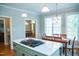 Bright kitchen island with a gas cooktop and a view to a sunny breakfast nook at 7371 Leasburg Rd, Roxboro, NC 27574