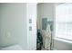 Bright laundry room with utility sink, washer, dryer, storage, and ironing board at 7371 Leasburg Rd, Roxboro, NC 27574