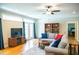 Bright living room featuring hardwood floors, ceiling fan, and a comfortable seating area at 7371 Leasburg Rd, Roxboro, NC 27574