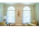 Bright and airy living room featuring hardwood floors, arched windows, and elegant decor at 7371 Leasburg Rd, Roxboro, NC 27574