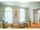 Well-lit living room with hardwood floors, arched windows, and a comfortable seating area at 7371 Leasburg Rd, Roxboro, NC 27574