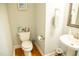 Cozy powder room with pedestal sink and hardwood floors at 7371 Leasburg Rd, Roxboro, NC 27574
