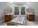 Bright bathroom features double sinks, soaking tub with tile surround, and decorative ceilings at 952 Glover Rd, Dunn, NC 28334