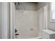 Clean bathroom featuring a tub/shower combo with white tile surround and handheld shower at 952 Glover Rd, Dunn, NC 28334