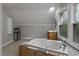 Soaking tub with tile surround, single sink, and decorative ceilings in this bathroom at 952 Glover Rd, Dunn, NC 28334