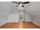 Open bedroom with hardwood floors, decorative ceiling and doorway to bathroom at 952 Glover Rd, Dunn, NC 28334