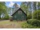 Exterior view of a two story home with green siding, surrounded by mature trees at 952 Glover Rd, Dunn, NC 28334