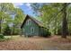Rear exterior view of a two story home with green siding and lots of natural light at 952 Glover Rd, Dunn, NC 28334