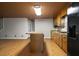 Spacious kitchen area with wood cabinets, island, and adjacent living space at 952 Glover Rd, Dunn, NC 28334