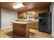 Spacious kitchen area featuring an island and hardwood floors, and a wood ceiling at 952 Glover Rd, Dunn, NC 28334