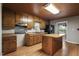 Traditional kitchen with wood cabinets, an island, and modern appliances under a wood ceiling at 952 Glover Rd, Dunn, NC 28334
