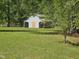 Rear view of a storage barn with a green lawn at 952 Glover Rd, Dunn, NC 28334