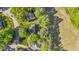An aerial view of homes surrounded by lush green trees in a beautiful neighborhood at 5113 Windance Pl, Holly Springs, NC 27540