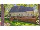 Rear view featuring a wooden deck with outdoor seating and lush greenery offering relaxation and privacy at 5113 Windance Pl, Holly Springs, NC 27540