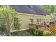Home exterior view showcasing a wooden deck, outdoor seating, and a lush, green backyard at 5113 Windance Pl, Holly Springs, NC 27540