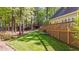View of manicured backyard with wooden decks on a sunny day at 5113 Windance Pl, Holly Springs, NC 27540
