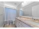 Bathroom with double vanity, granite countertop, and shower-tub combo at 5113 Windance Pl, Holly Springs, NC 27540