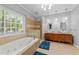 A luxurious bathroom with double sinks, granite counters, a soaking tub and tiled shower at 5113 Windance Pl, Holly Springs, NC 27540