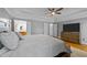This bedroom boasts tray ceilings, a ceiling fan, and neutral decor with a luxurious bed at 5113 Windance Pl, Holly Springs, NC 27540