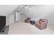 Bonus room features two leather armchairs, ceiling fan, window, and TV at 5113 Windance Pl, Holly Springs, NC 27540