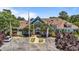 Exterior view of the well-maintained clubhouse and parking lot with attractive landscaping at 5113 Windance Pl, Holly Springs, NC 27540